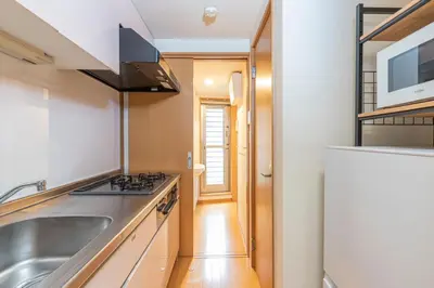 a kitchen with a sink and a refrigerator at Asakusa and Ueno Area, 2 Minutes to Iriya Station, Very Convenient in Tokyo