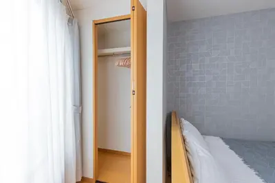 a bedroom with a closet with a bed and a mirror at Asakusa and Ueno Area, 2 Minutes to Iriya Station, Very Convenient in Tokyo