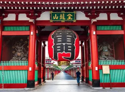 a building with a sign with a face on it at Asakusa and Ueno Area, 2 Minutes to Iriya Station, Very Convenient in Tokyo
