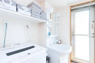a white bathroom with a sink and a toilet at Asakusa and Ueno Area, 2 Minutes to Iriya Station, Very Convenient in Tokyo
