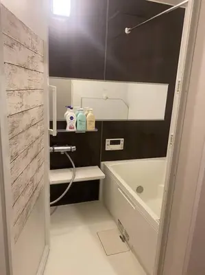 a bathroom with a shower and a tub and a sink at \u5c0f\u5ca9\u6c11\u6cca\u5bbf in Tokyo