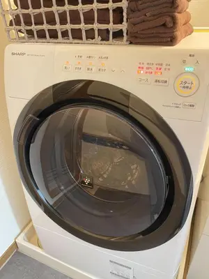 a white washing machine sitting in a kitchen at Alo BnB 10 - Near AKIHABARA, UENO, ASAKUSA, TOKYO SKY TREE - Self check-in in Tokyo