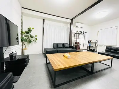 a living room with a table and a couch at Alo BnB 10 - Near AKIHABARA, UENO, ASAKUSA, TOKYO SKY TREE - Self check-in in Tokyo