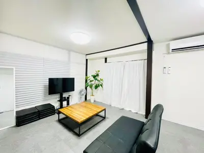 a living room with a couch and a coffee table at Alo BnB 10 - Near AKIHABARA, UENO, ASAKUSA, TOKYO SKY TREE - Self check-in in Tokyo