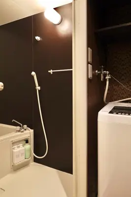 a shower stall in a bathroom with a stove at \u6cca\u9732Hakuro 1\u968e in Tokyo