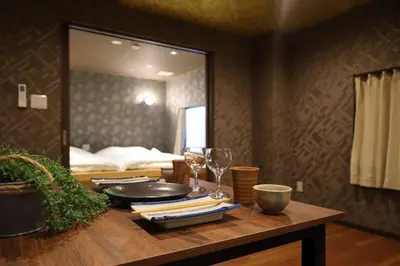 a table with wine glasses and a mirror in a room at \u6cca\u9732Hakuro 1\u968e in Tokyo