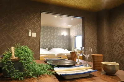a table with wine glasses and a mirror in a room at \u6cca\u9732Hakuro 1\u968e in Tokyo