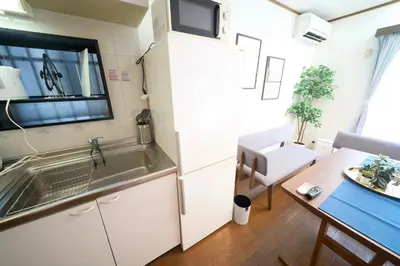 a small kitchen with a sink and a table at FINOA Residential Suite Kita-Ikebukuro in Tokyo