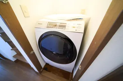 a washing machine in the corner of a room at FINOA Residential Suite Kita-Ikebukuro in Tokyo