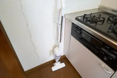 a kitchen with a stove and a white refrigerator at FINOA Residential Suite Kita-Ikebukuro in Tokyo