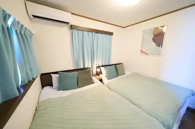 two beds sitting next to each other in a bedroom at FINOA Residential Suite Kita-Ikebukuro in Tokyo