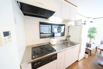 a small kitchen with a stove and a sink at FINOA Residential Suite Kita-Ikebukuro in Tokyo