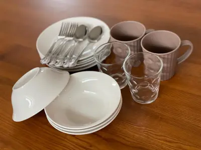 a group of plates and cups and utensils on a table at COTO Premium Shibuya A in Tokyo
