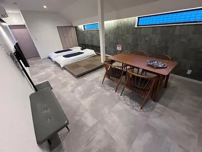a room with a table and a bed in a room at COTO Premium Shibuya A in Tokyo