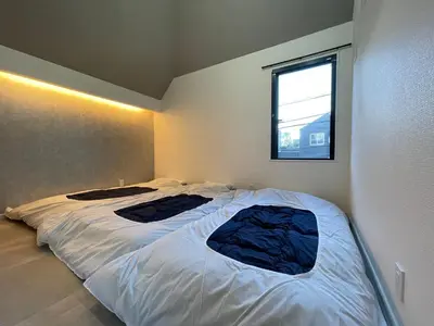 a bedroom with two beds in it with a window at COTO Premium Shibuya A in Tokyo