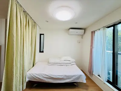 a small bedroom with a bed and a window at \u4e1c\u4eac\u6c60\u888b\u57ce\u5e02\u4f4f\u5bbf-Ikebukuro Urban Stay in Tokyo
