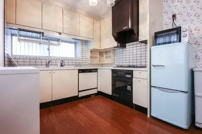 a kitchen with white appliances and a wooden floor at \u677e\u304c\u4e181\u4e01\u76ee in Tokyo