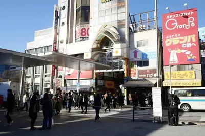 a crowd of people walking on a busy city street at \u677e\u304c\u4e181\u4e01\u76ee in Tokyo