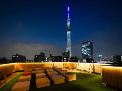 a view of a city skyline at night with a building at OCICA OSHIAGE TOKYO by R HOTEL in Tokyo