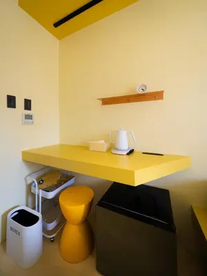 a yellow desk in a room with a toilet at OCICA OSHIAGE TOKYO by R HOTEL in Tokyo