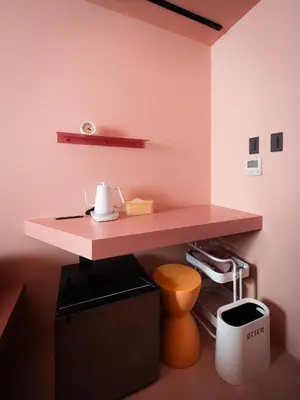 a pink desk in a room with a toilet at OCICA OSHIAGE TOKYO by R HOTEL in Tokyo