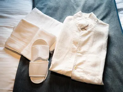 a man with a white shirt and a pair of shoes at OCICA OSHIAGE TOKYO by R HOTEL in Tokyo