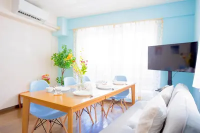 a living room with a table and a tv at MIKO'S HOUSE SETAGAYA, Peaceful Tokyo Home Near Shinjuku, Experience Authentic Local Living, Lucky Cat Temple, Super Market 東京の家 新宿10分 隠れ家カフェ 豪徳寺 in Tokyo