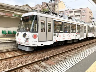 a white train on the tracks at a train station at MIKO'S HOUSE SETAGAYA, Peaceful Tokyo Home Near Shinjuku, Experience Authentic Local Living, Lucky Cat Temple, Super Market 東京の家 新宿10分 隠れ家カフェ 豪徳寺 in Tokyo