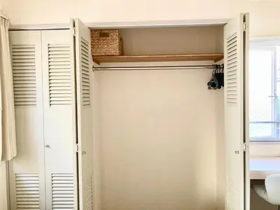 a closet with white doors and a window at MIKO'S HOUSE SETAGAYA, Peaceful Tokyo Home Near Shinjuku, Experience Authentic Local Living, Lucky Cat Temple, Super Market 東京の家 新宿10分 隠れ家カフェ 豪徳寺 in Tokyo