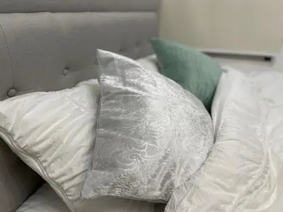 a white pillow sitting on top of a couch at GraceCourt Oyama Near Ikebukuro Studio Apartment in Tokyo