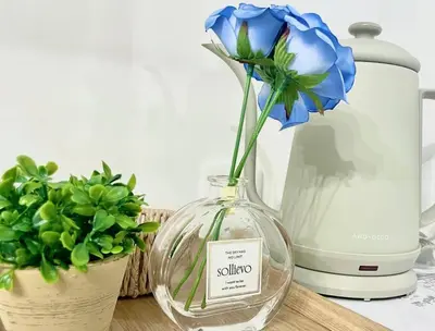 a blue flower in a glass vase next to a blender at GraceCourt Oyama Near Ikebukuro Studio Apartment in Tokyo