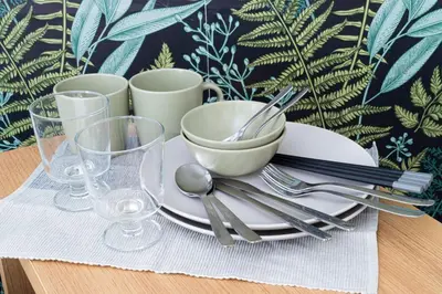 a table with a plate with a bowl and silverware at GraceCourt Oyama Near Ikebukuro Studio Apartment in Tokyo