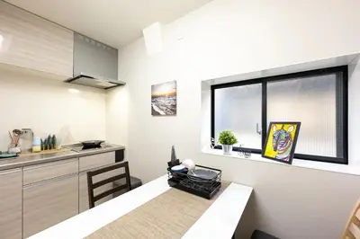 a small kitchen with a table and a window at YJ-HOTEL kamiikebukuro 2F \u5317\u6c60\u888b5\u5206\u949f \u65b0\u88c5\u4e0a\u7ebf 59\u5e73\u65b9 in Tokyo