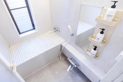 a white bathroom with a tub and a mirror at Charming Guesthouse in the Heart of Okubo \u4e36Steps to Metro and Convenient Travel! EoW4 in Tokyo