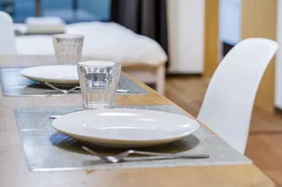 a table with two plates and a glass on it at Charming Guesthouse in the Heart of Okubo \u4e36Steps to Metro and Convenient Travel! EoW4 in Tokyo