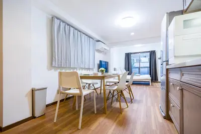 a kitchen and dining room with a table and chairs at Charming Guesthouse in the Heart of Okubo \u4e36Steps to Metro and Convenient Travel! EoW4 in Tokyo
