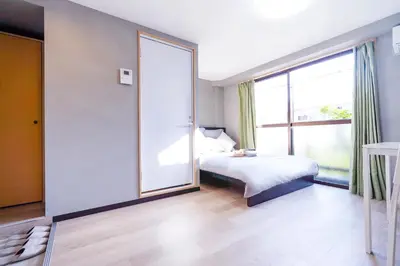 a bedroom with a bed and a large window at CG Charming Guesthouse in the Heart of Okubo \u4e36Steps to Metro and Convenient Travel! SoS4 in Tokyo