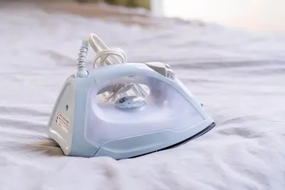 a blue phone sitting on top of a blanket at CG Charming Guesthouse in the Heart of Okubo \u4e36Steps to Metro and Convenient Travel! SoS4 in Tokyo