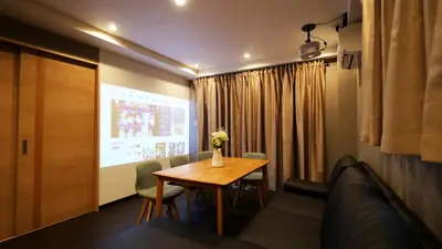 a room with a table and a couch and a screen at Charming Guesthouse in the Heart of Okubo \u4e36Steps to Metro and Convenient Travel! YoS4 in Tokyo