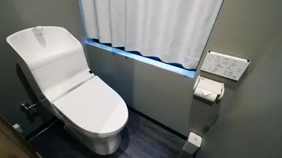 a bathroom with a white toilet and a window at Charming Guesthouse in the Heart of Okubo \u4e36Steps to Metro and Convenient Travel! YoS4 in Tokyo