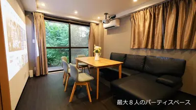 a living room with a couch and a table at Charming Guesthouse in the Heart of Okubo \u4e36Steps to Metro and Convenient Travel! YoS4 in Tokyo