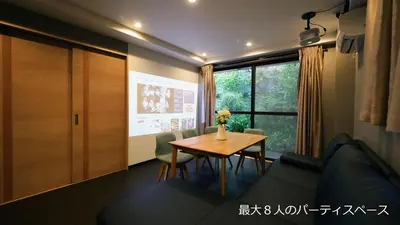 a room with a table and a couch and a window at Charming Guesthouse in the Heart of Okubo \u4e36Steps to Metro and Convenient Travel! YoS4 in Tokyo