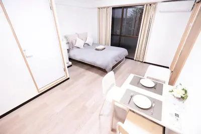 a small living room with a bed and a table at CG Charming Guesthouse in the Heart of Okubo \u4e36Steps to Metro and Convenient Travel! YoE4 in Tokyo