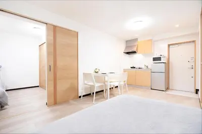 a kitchen and dining room with a table and chairs at CG Charming Guesthouse in the Heart of Okubo \u4e36Steps to Metro and Convenient Travel! YoE4 in Tokyo