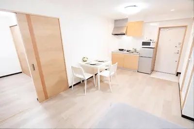 a kitchen and dining room with a table and chairs at CG Charming Guesthouse in the Heart of Okubo \u4e36Steps to Metro and Convenient Travel! YoE4 in Tokyo