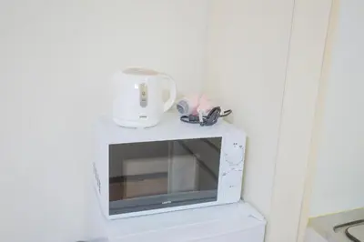 a white microwave with a blender on top of it at Charming Guesthouse in the Heart of Okubo \u4e36Steps to Metro and Convenient Travel! EoS11 in Tokyo