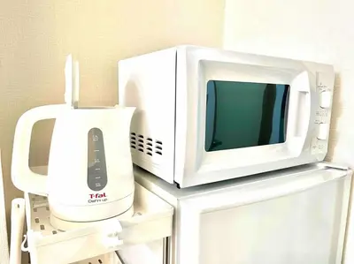 a microwave oven sitting on top of a appliance at 2 Minutes Walk to Ikebukuro Station, Central Tokyo and Very Convenient in Tokyo