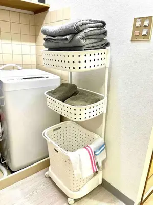 a laundry room with a washing machine and towels at 2 Minutes Walk to Ikebukuro Station, Central Tokyo and Very Convenient in Tokyo