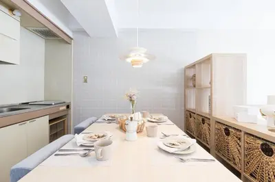 a kitchen with a table with plates and utensils at 2 Minutes Walk to Ikebukuro Station, Central Tokyo and Very Convenient in Tokyo