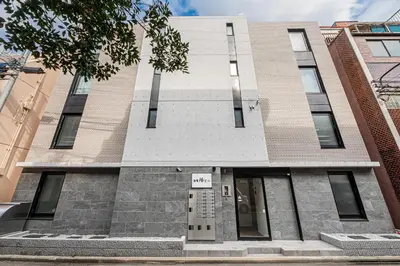 a building with a sign on the front of it at \u65b0\u5bbf16 Shinjuku16 in Tokyo